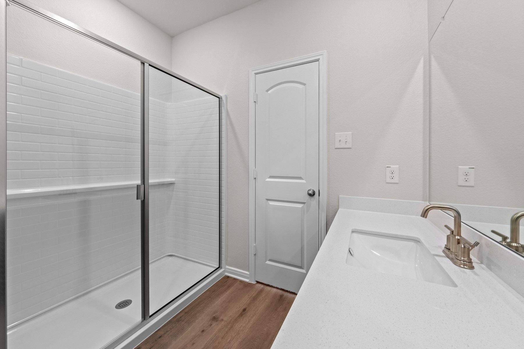 The master bathroom of the Piper has a large vanity space and glass, walk-in shower.