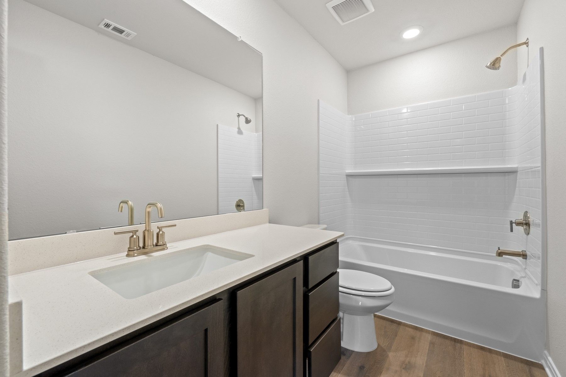 The secondary bathroom of the Piper has a large vanity space and shower-tub combo.