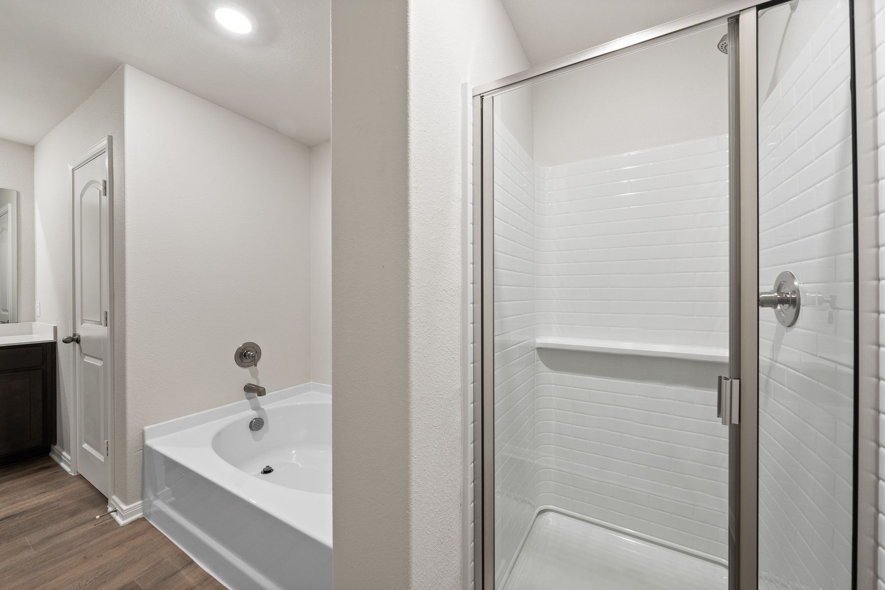 The master bathroom of the Rayburn has a glass, walk-in shower and garden tub.