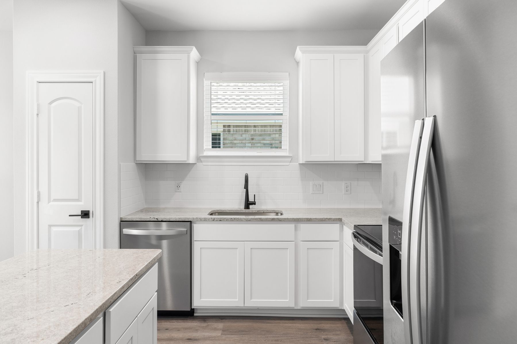 The kitchen of the Blanco has white wood cabinetry.