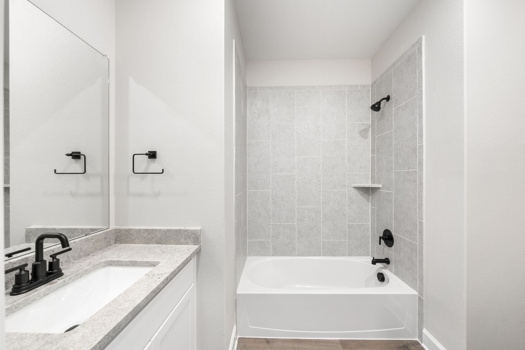 The secondary bathroom of the Blanco has a large vanity space and a shower-tub combo.