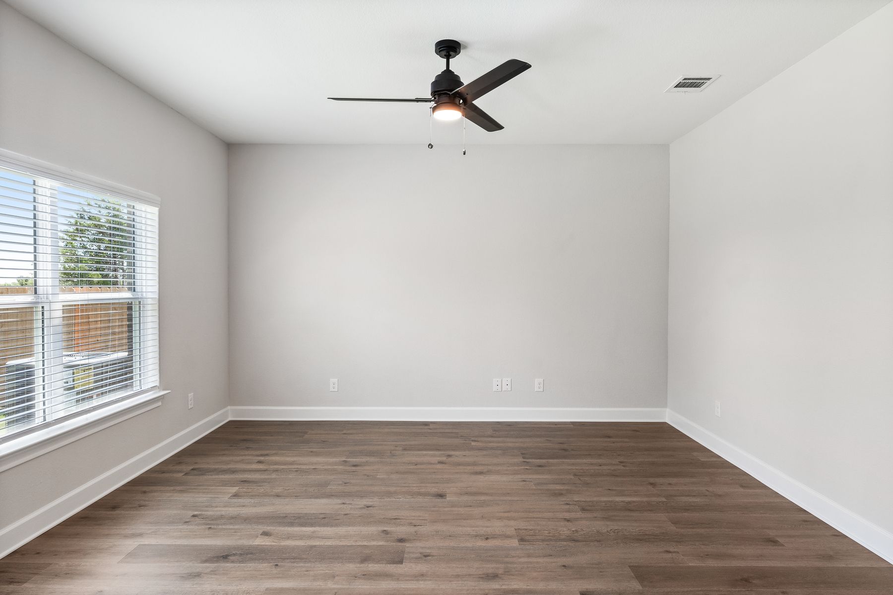 The family room of the Rio Grande has a large window that lets in great, natural light and backyard views.