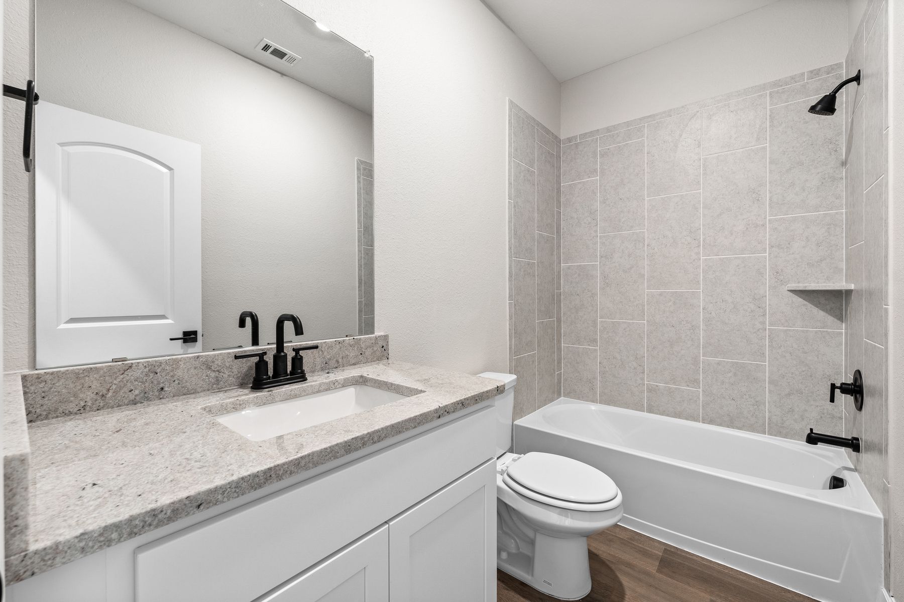 The secondary bathroom of the Rio Grande has a large vanity and shower-tub combo.