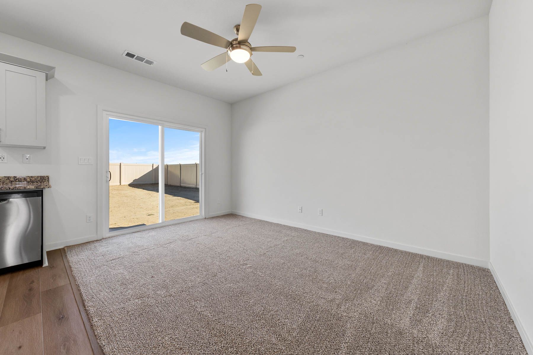 The family room is spacious with a ceiling fan.
