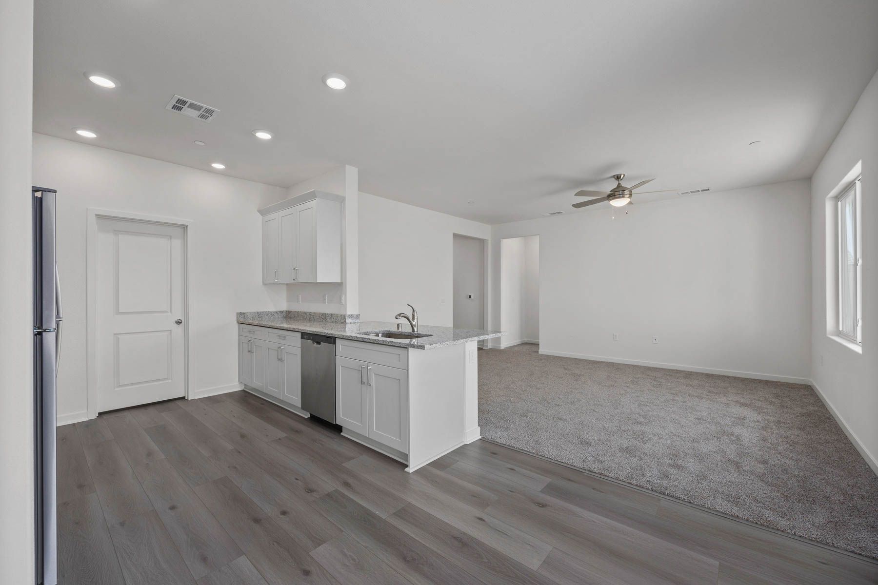 The family room is spacious with a ceiling fan.