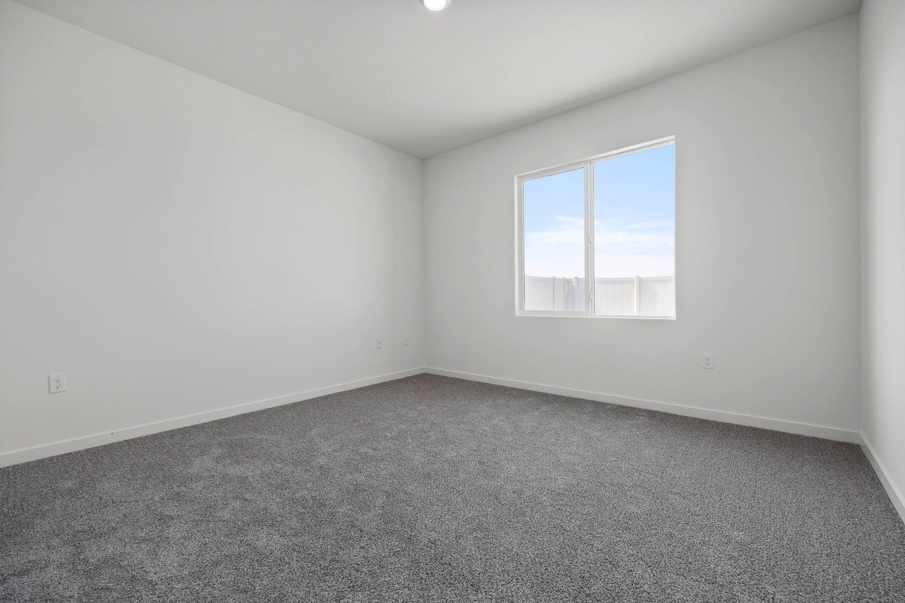 The master bedroom is spacious and has carpet.