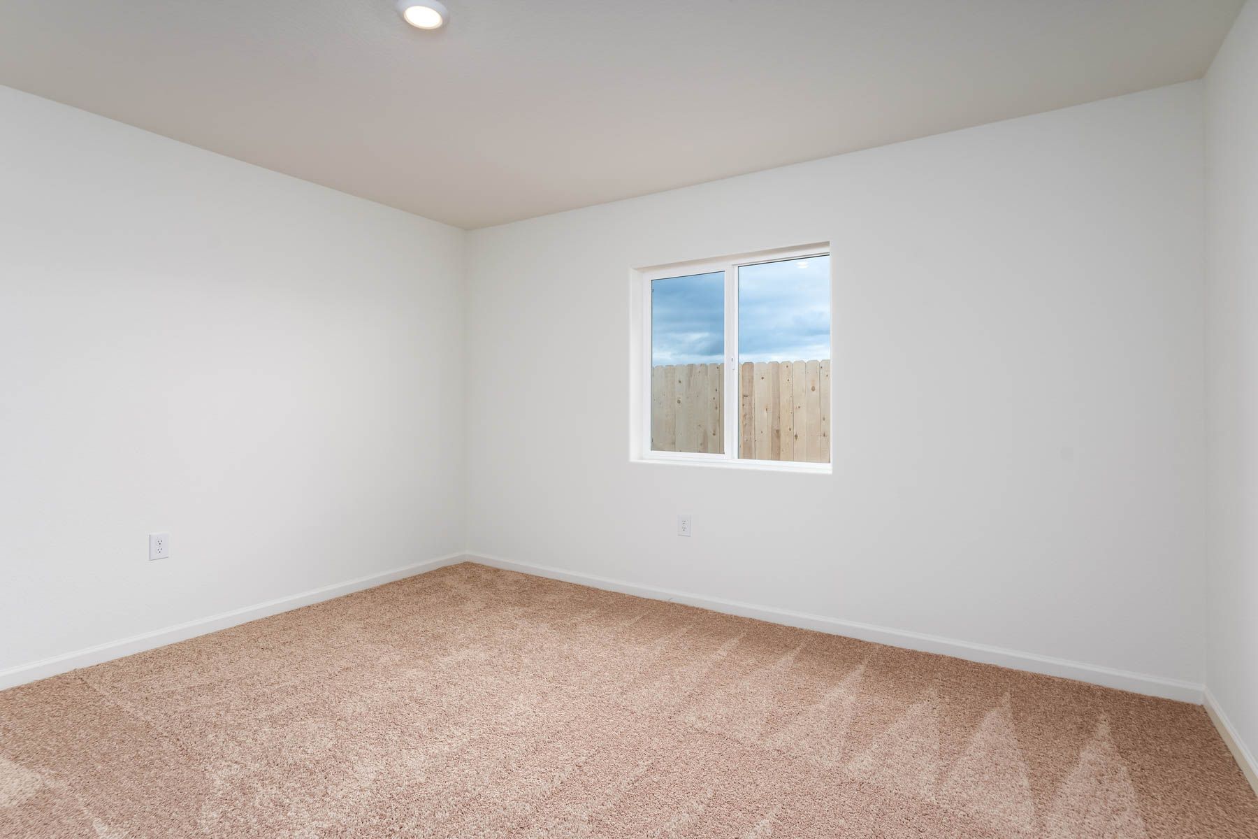 The master bedroom is spacious and has carpet.