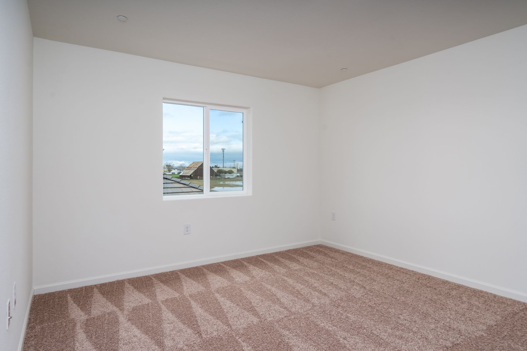 The master bedroom is spacious and has carpet.