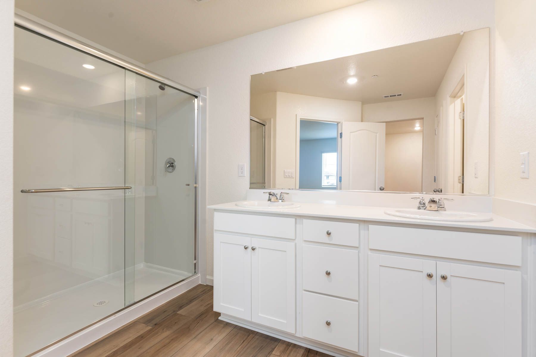 The master bathroom has a dual sink vanity.