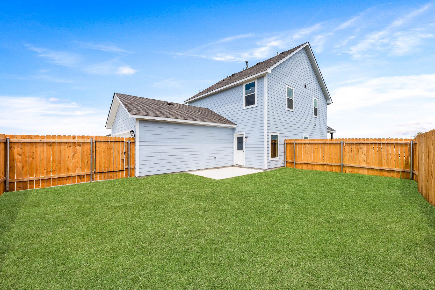The back yard of the Camelia is fully fenced in and has a patio space.