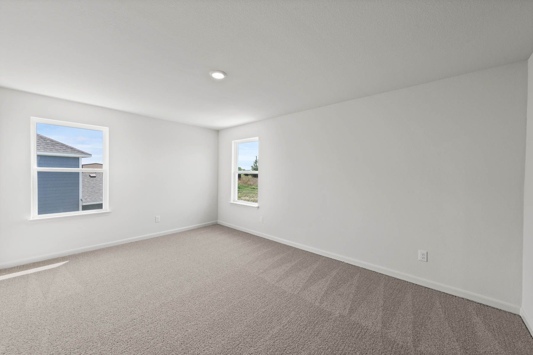 The master bedroom has large windows that let in great, natural light.