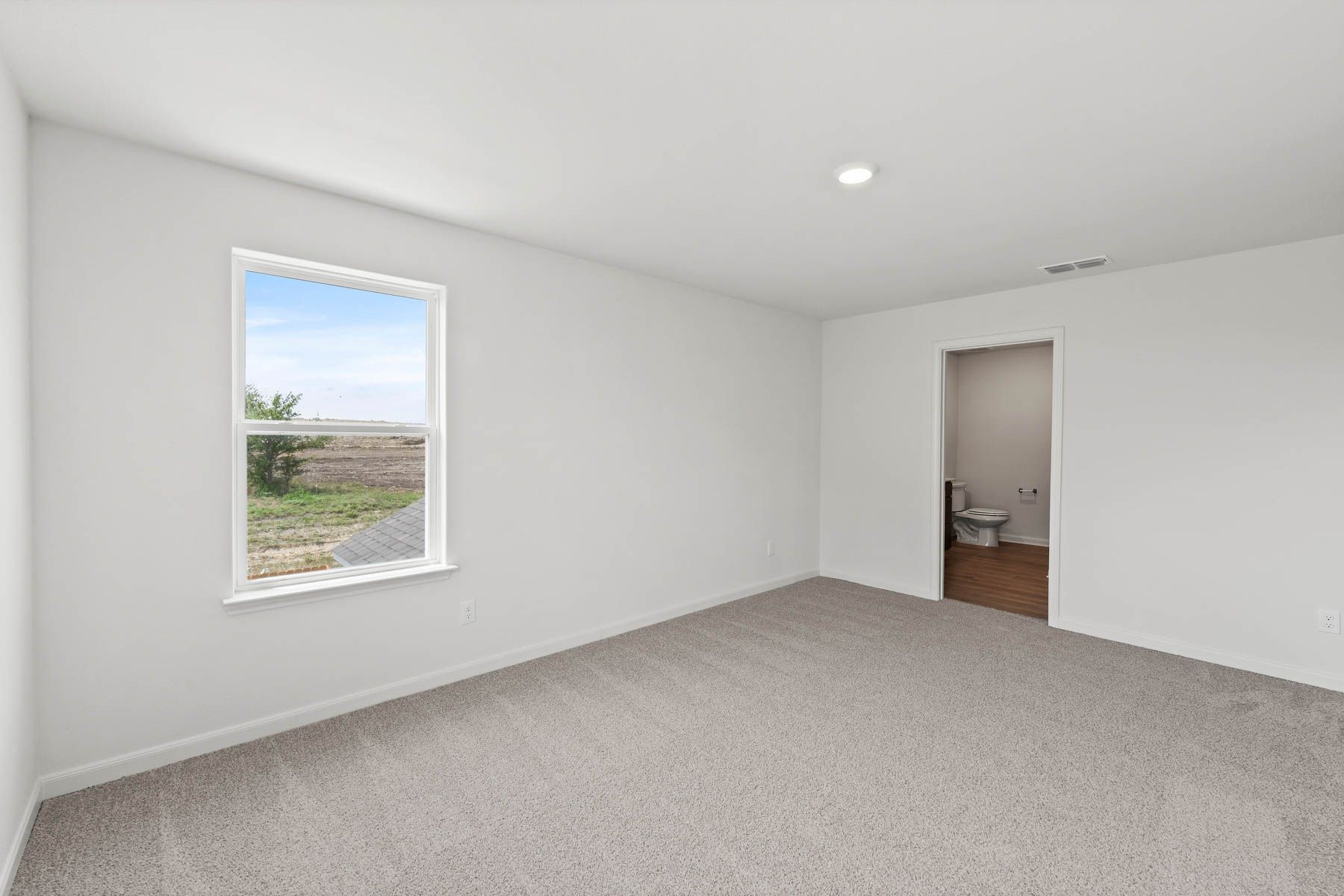 The master suite has a large bedroom, en-suite bathroom and spacious walk-in closet.