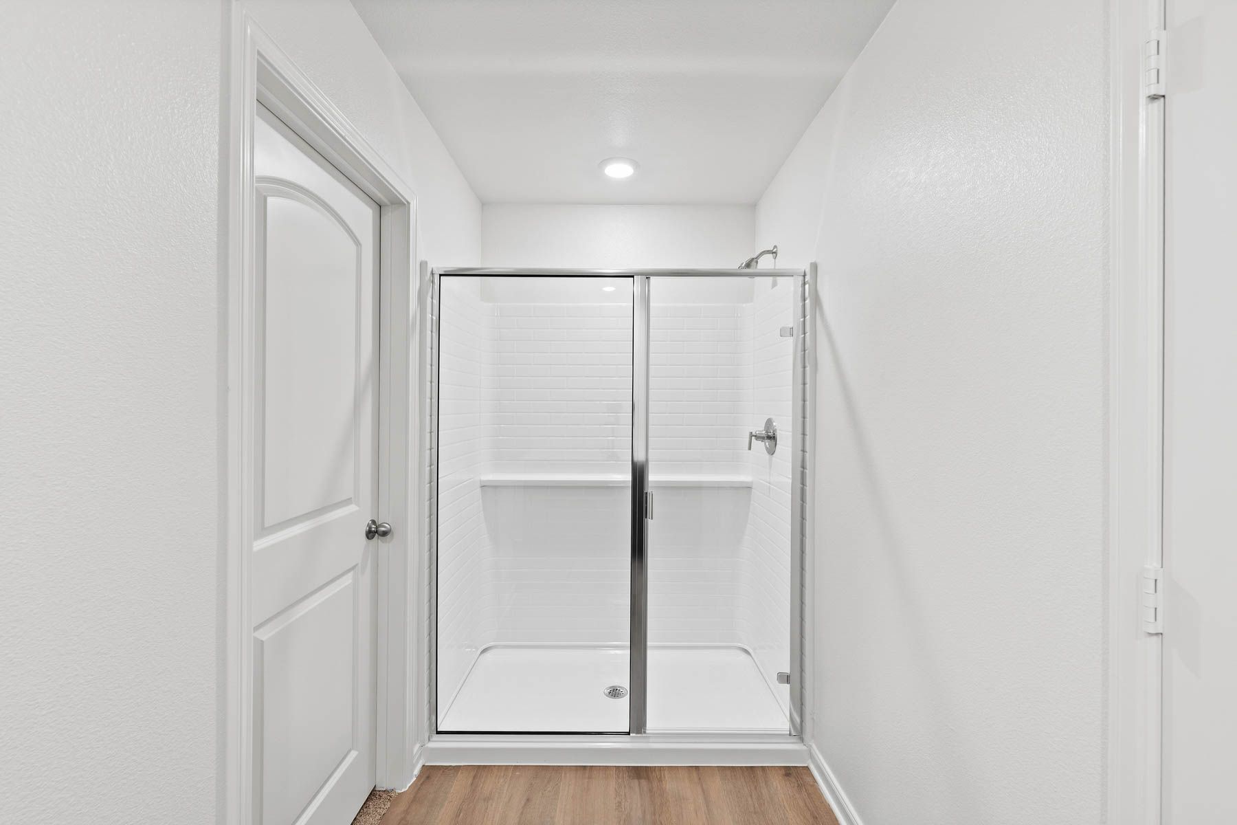 The master bathroom has a large walk-in, glass shower.