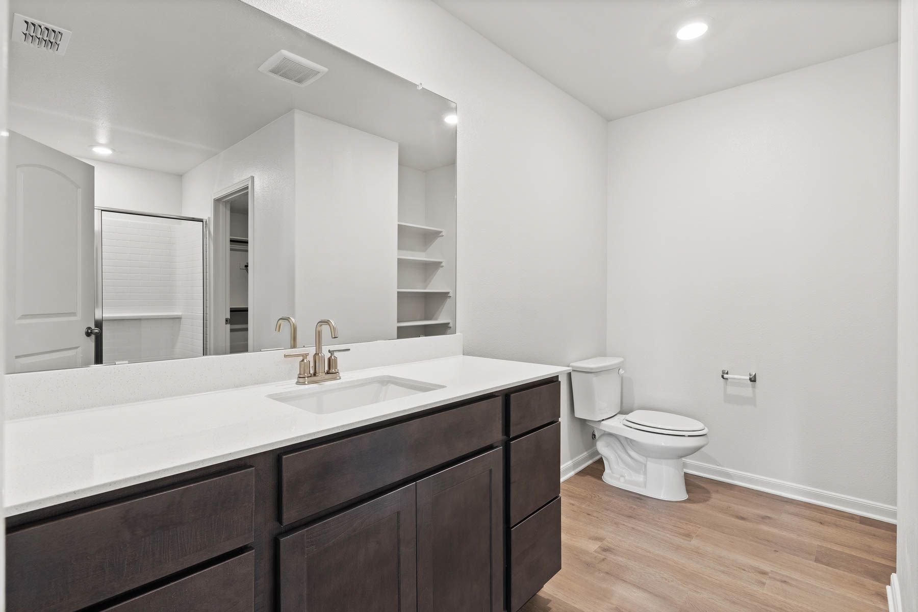 The master bathroom has a large vanity space.