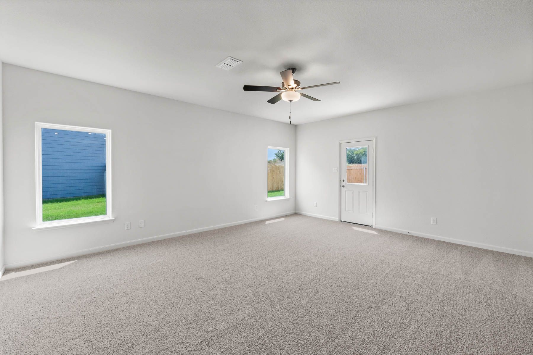 The spacious family room has large windows that let in great, natural light.