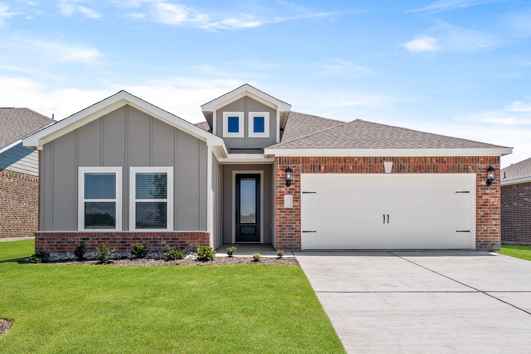 The one-story Sabine floor plan has a siding and brick exterior.