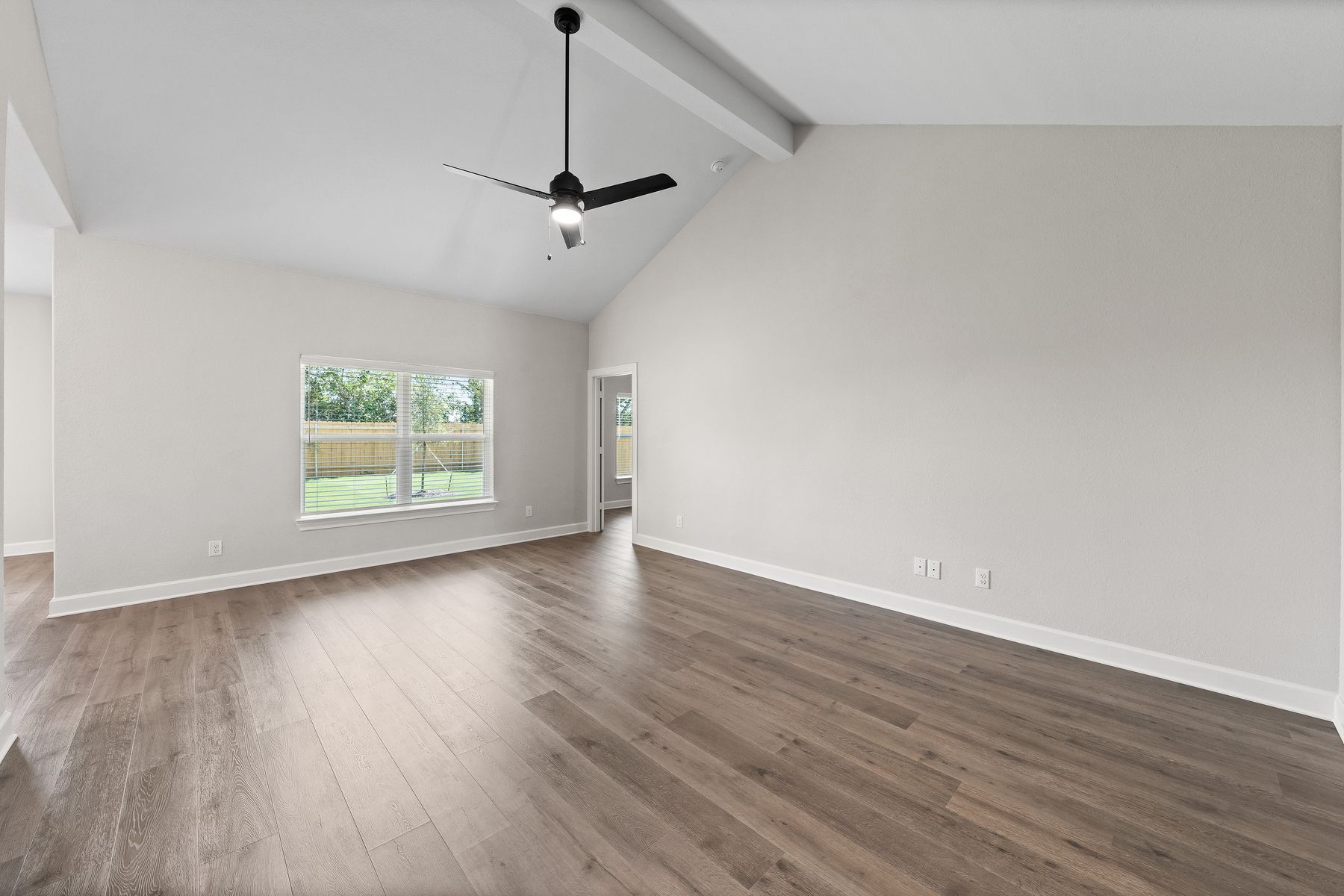 The family room of the Sabine floor plan has a large window that lets in great, natural light.