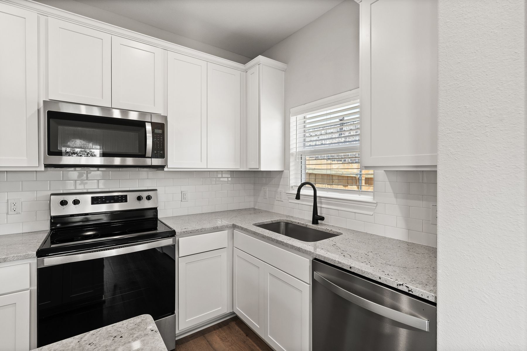 The kitchen of the Sabine floor plan has sprawling granite countertops.