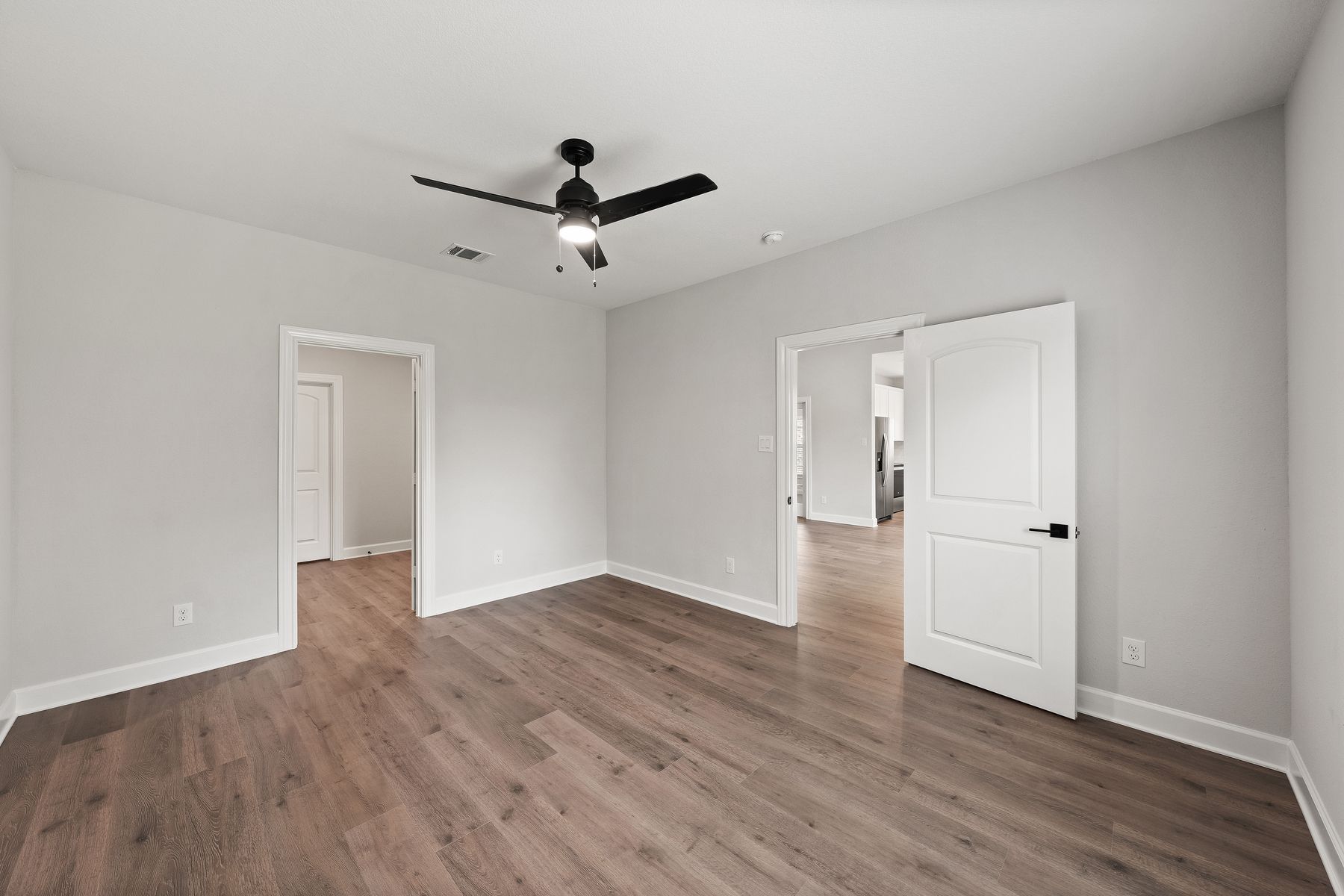 The master suite of the Sabine floor plan has a spacious bedroom, en-suite bathroom and walk-in closet.