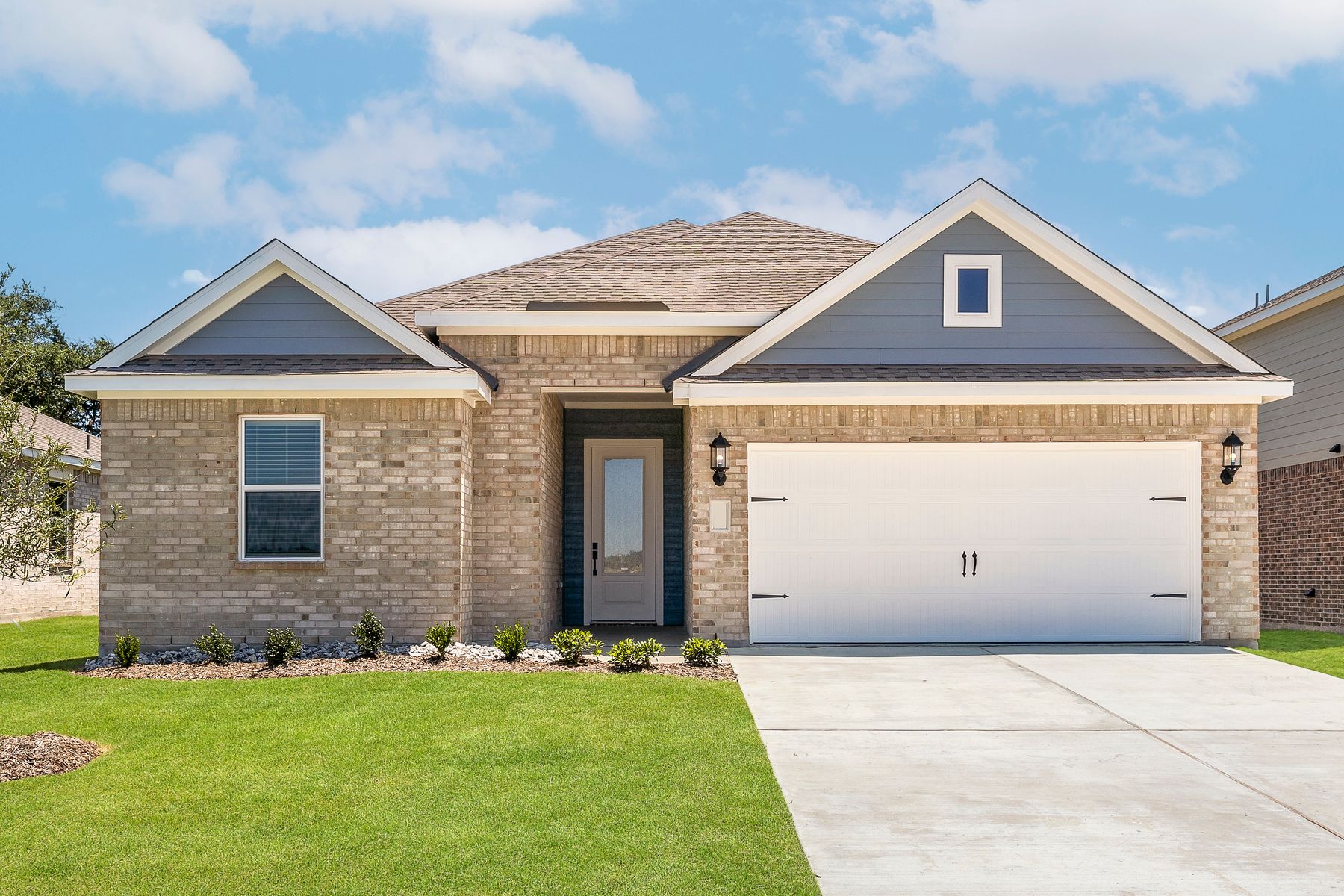 The one-story Reed floor plan has a brick exterior with siding accents.