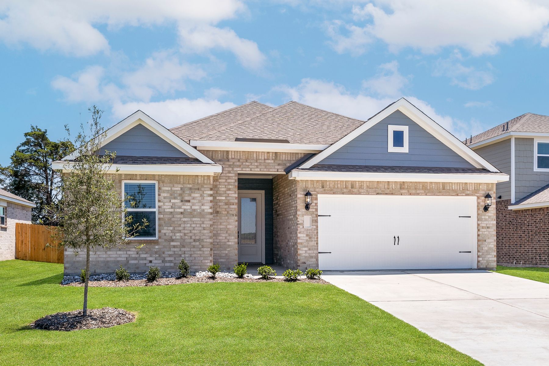 The one-story Reed floor plan has a brick exterior with siding accents.