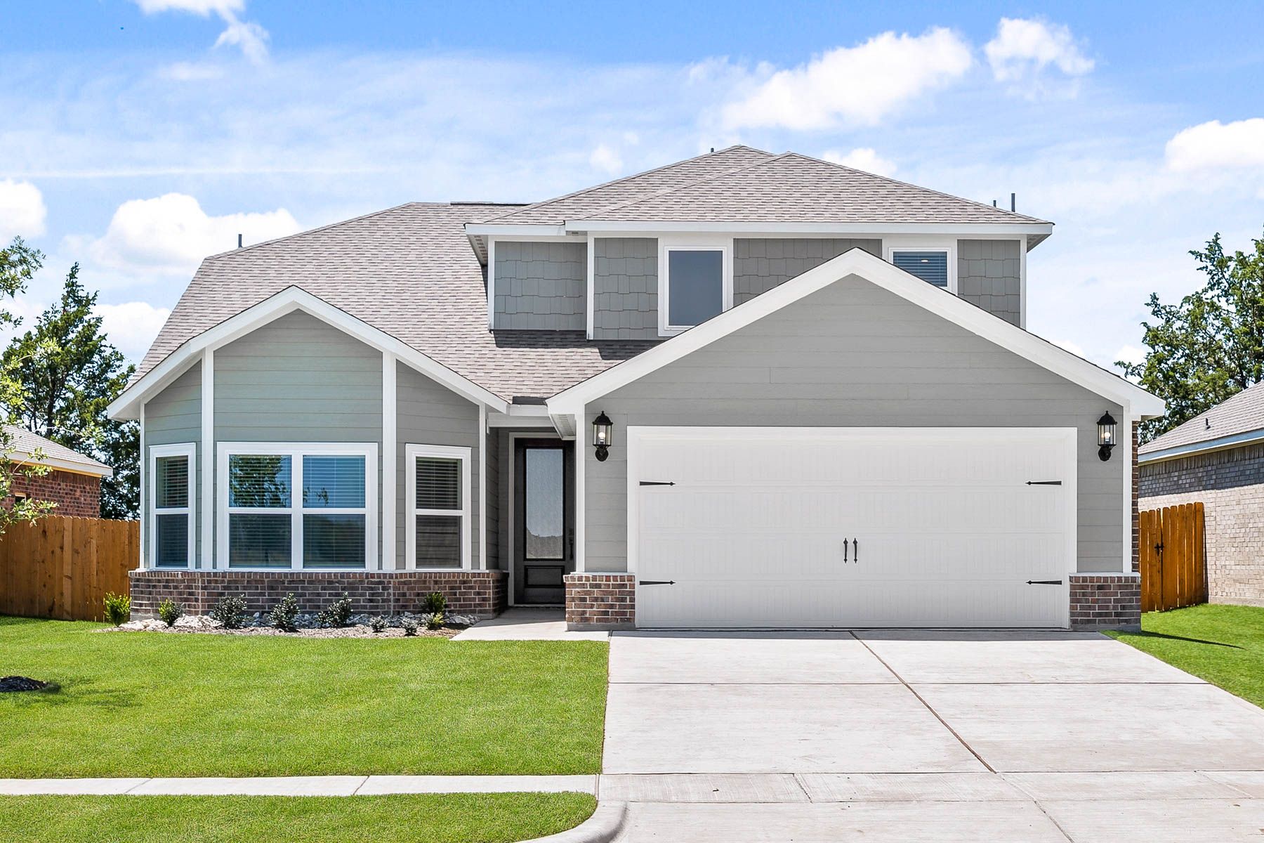 The two-story Cypress floor plan is a beautiful siding home with brick accents.