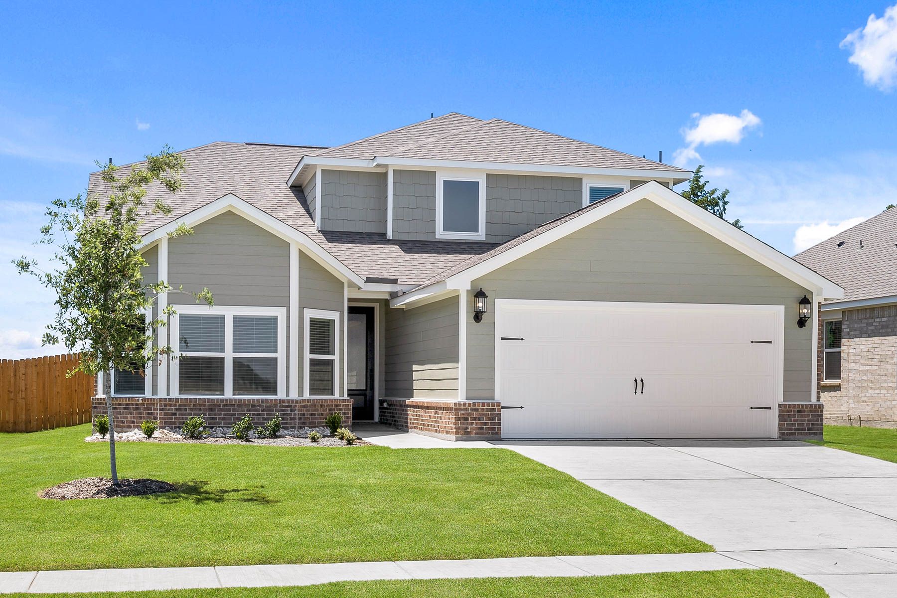 The two-story Cypress floor plan is a beautiful siding home with brick accents.