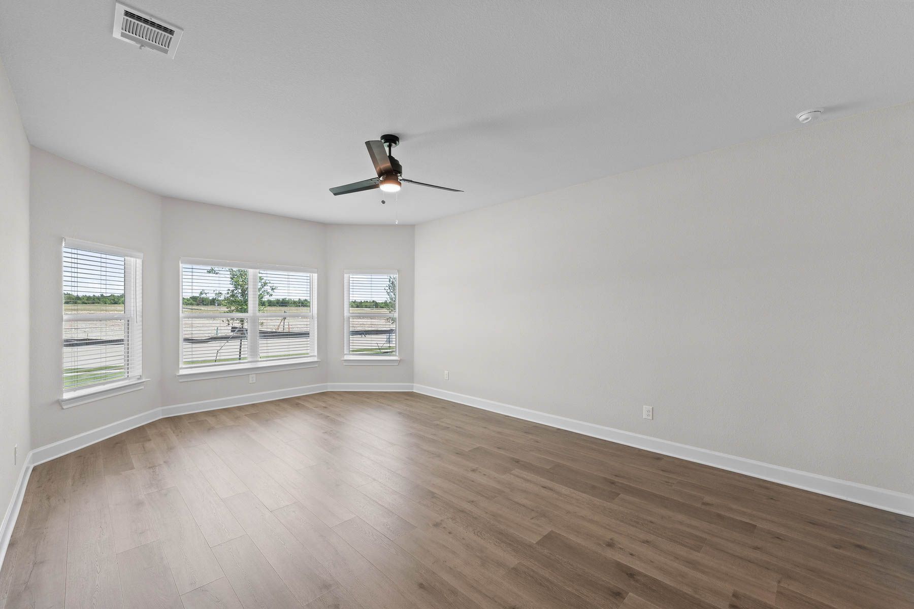 The master bedroom of the Cypress plan has three large windows that let in great, natural light.