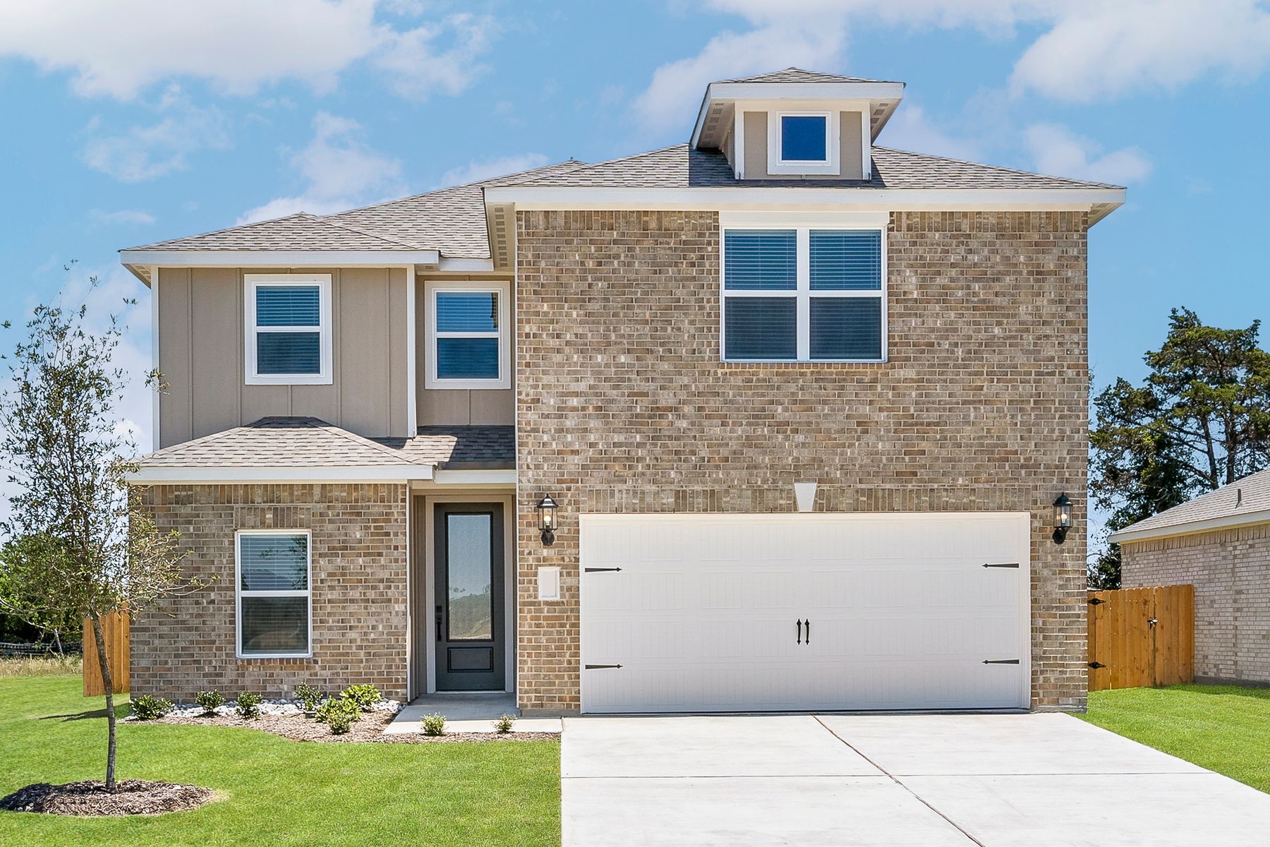 The two-story Driftwood plan has a gorgeous brick exterior with siding detail.