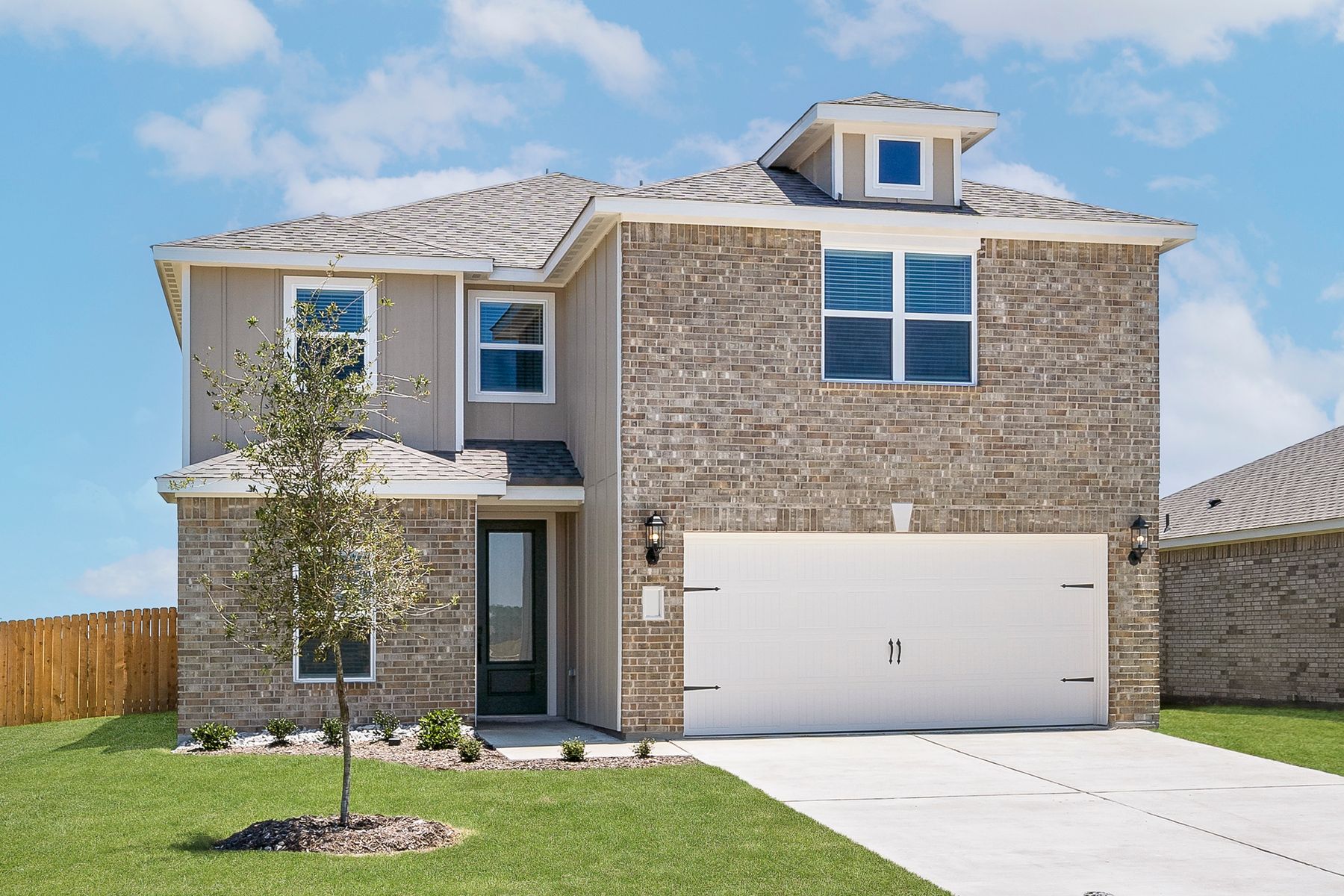 The two-story Driftwood plan has a gorgeous brick exterior with siding detail.