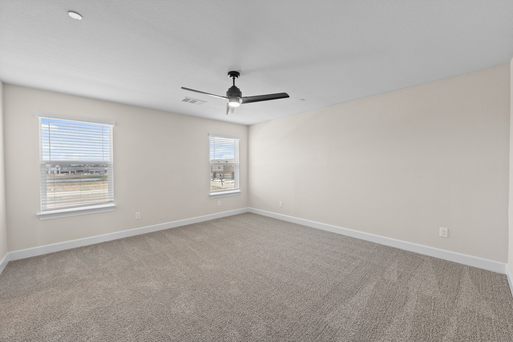 The master bedroom has large windows that let in great, natural light.