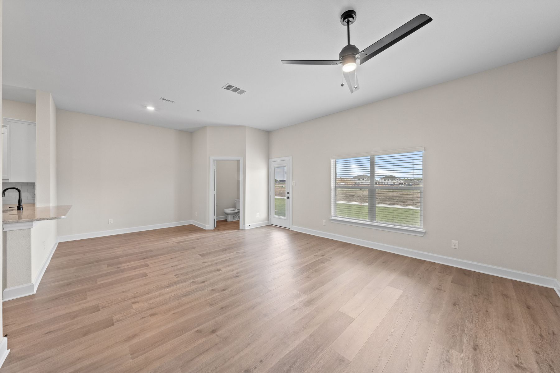 The family room has a large window that lets in great, natural light.