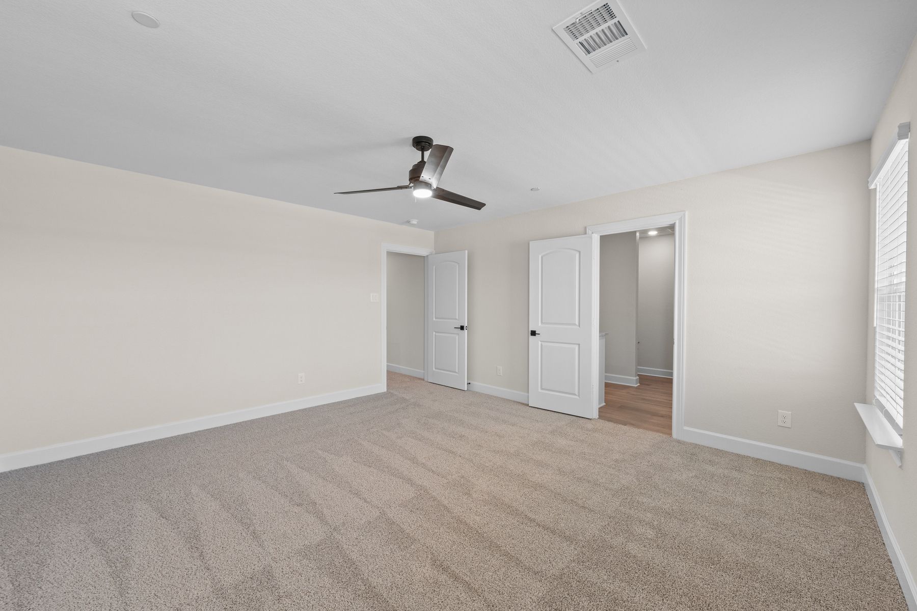 The master suite has a large bedroom, en-suite bathroom and spacious walk-in closet.