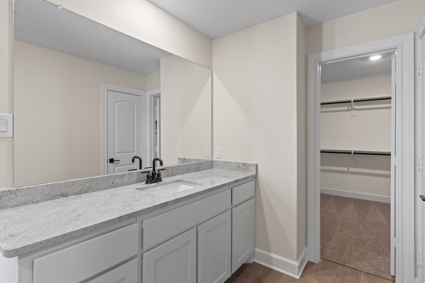 The master bathroom has a large vanity space.
