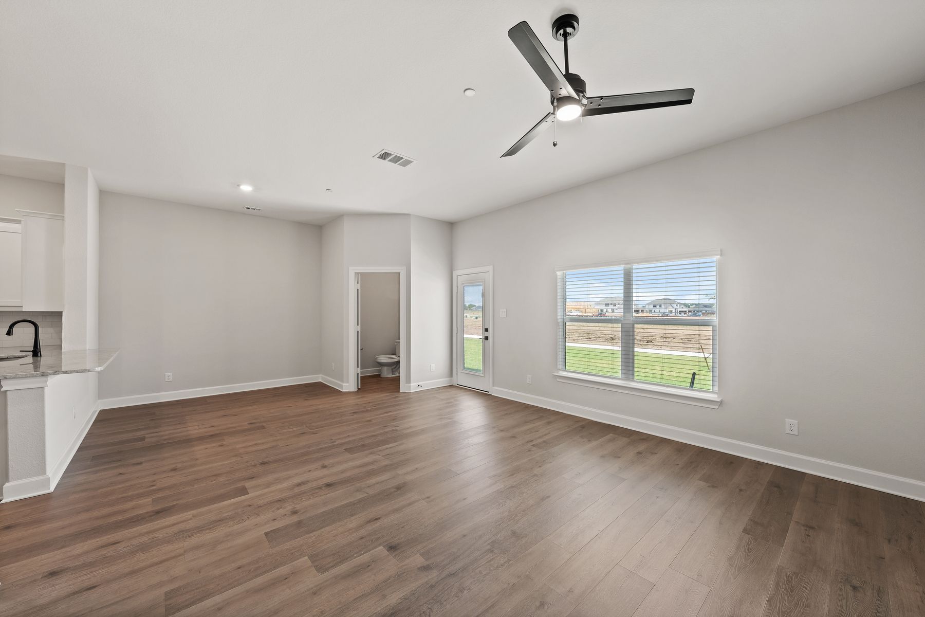 The open living areas connect the family room, dining area and kitchen.