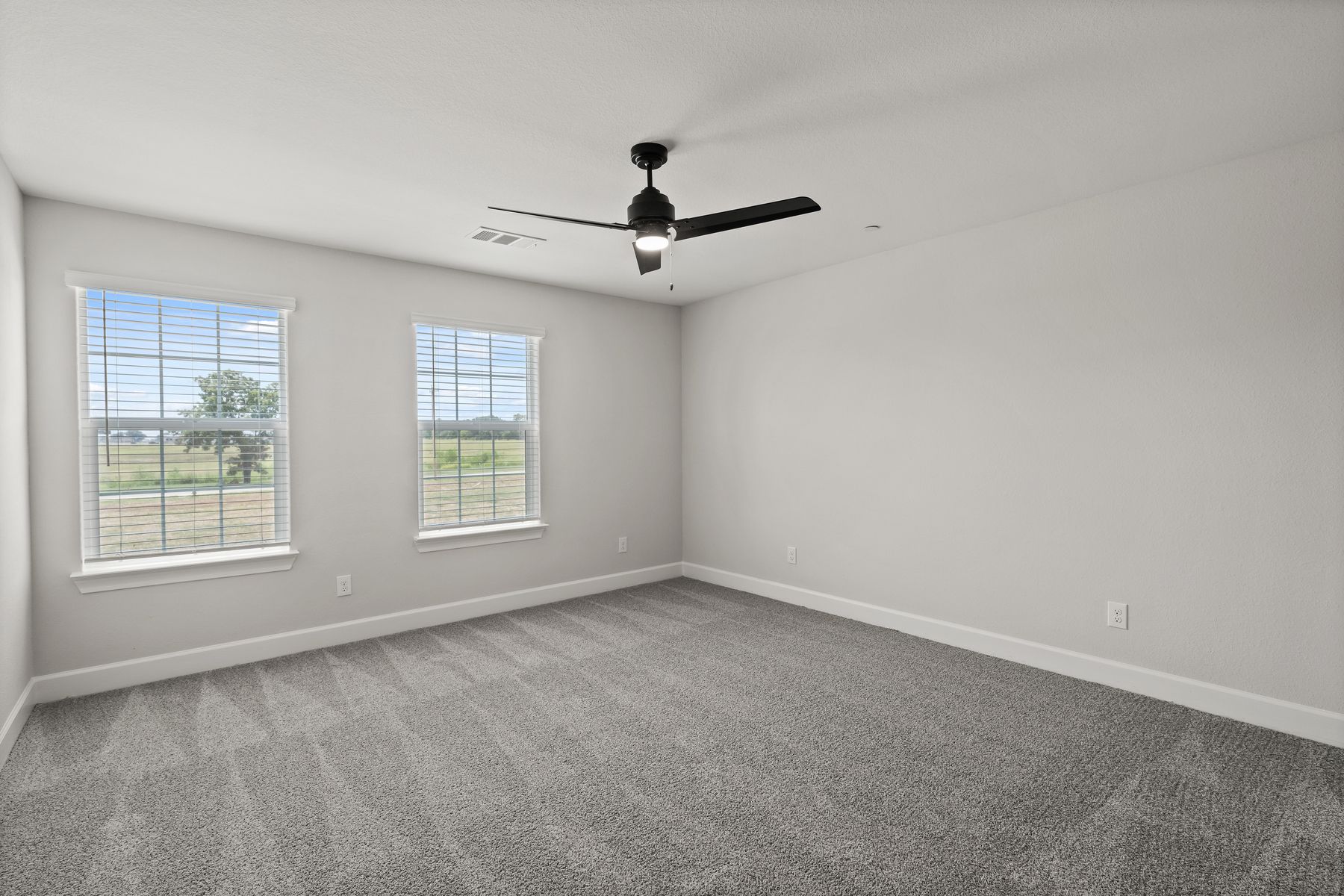 The master bedroom has two large windows that let in great, natural light.