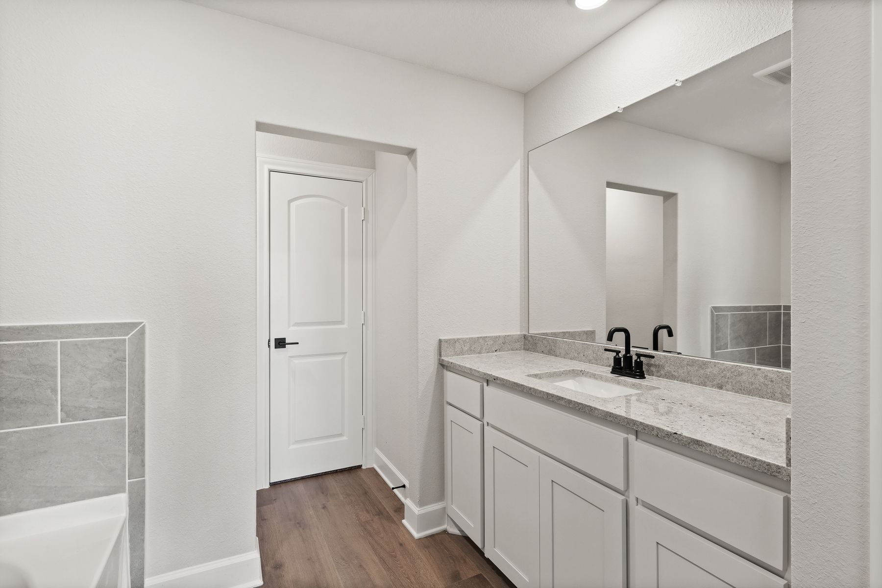 The master bathroom has a large vanity space.