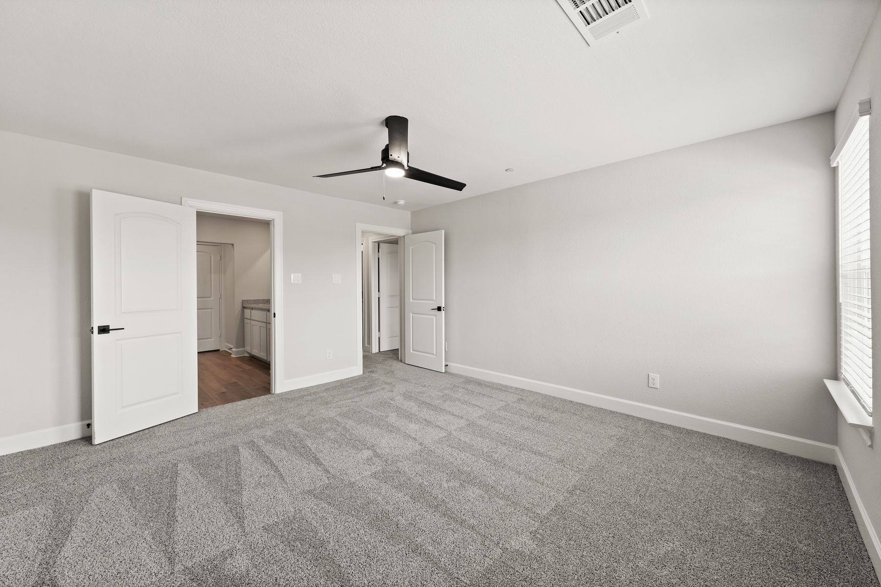 The master bedroom has two large windows that let in great, natural light.