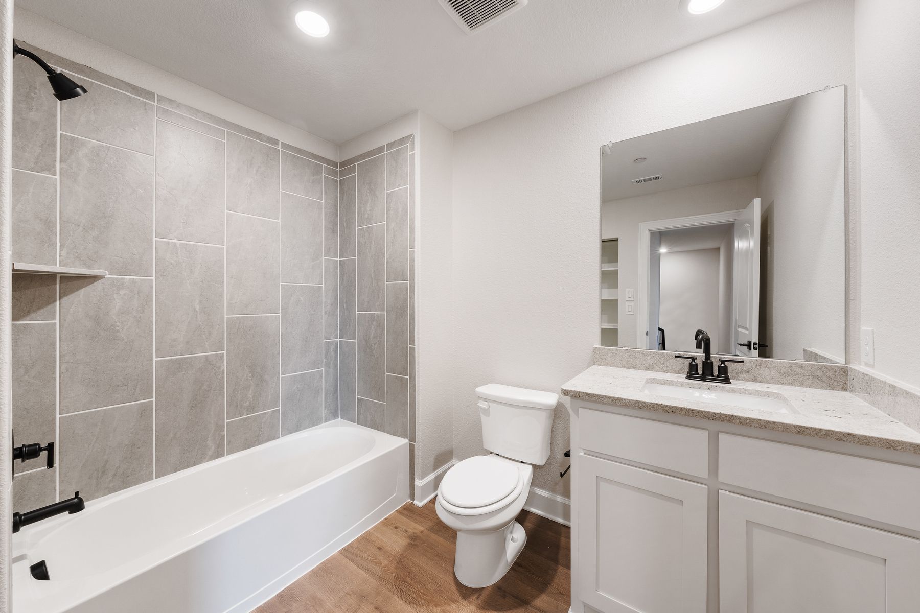 The secondary bathroom has a wonderful vanity space and shower-tub combo.