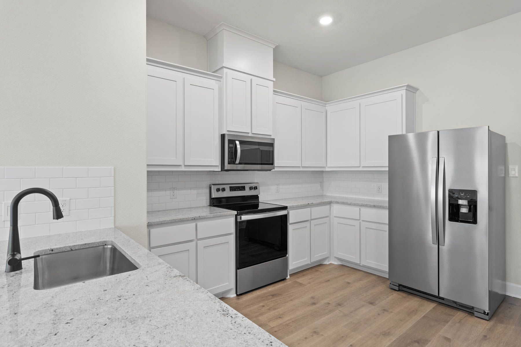 The kitchen of the Noma has beautiful white wood cabinetry.