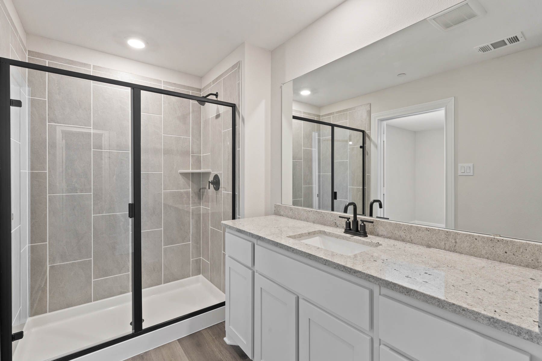 The master bathroom of the Noma has a large vanity space and a walk-in shower.