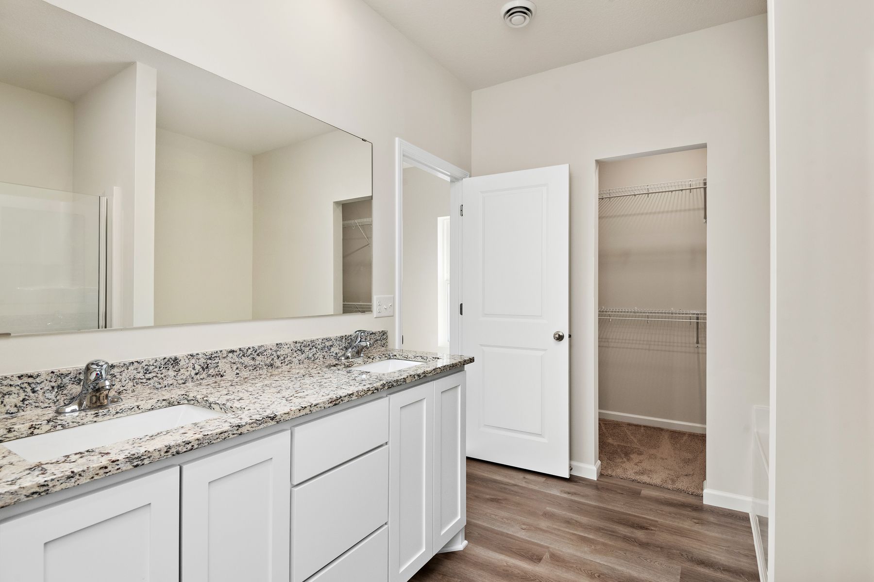 The master bathroom has a large dual sink vanity.