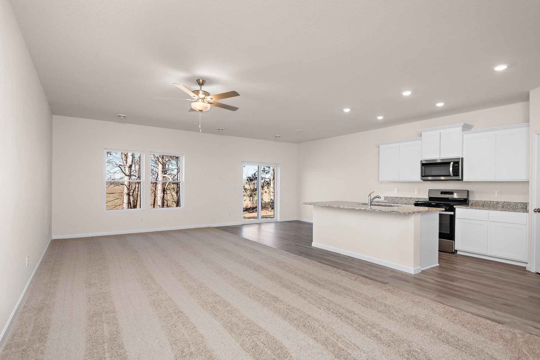 The family room is spacious with a ceiling fan.