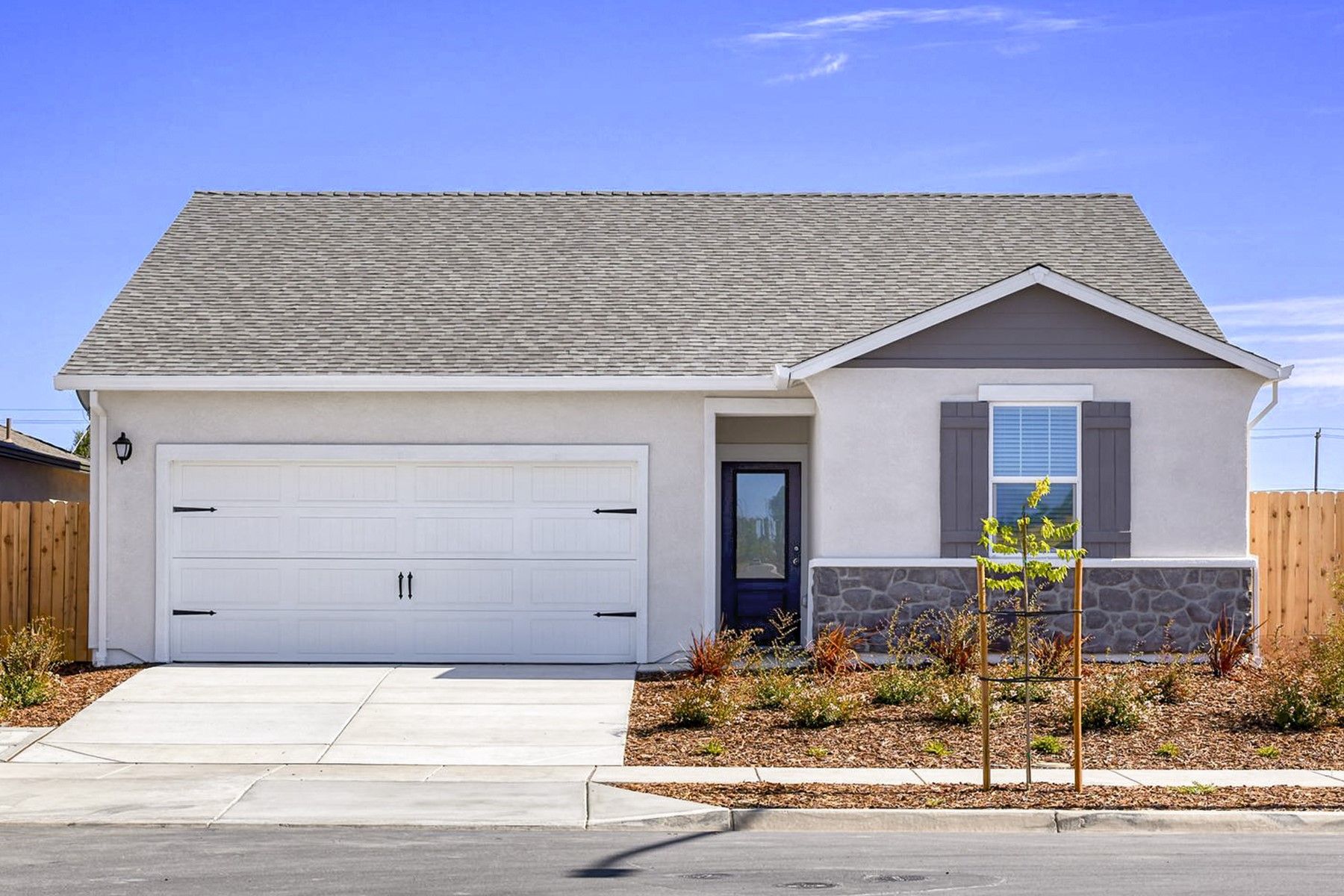 The Baker is a single story home with stucco and stone.