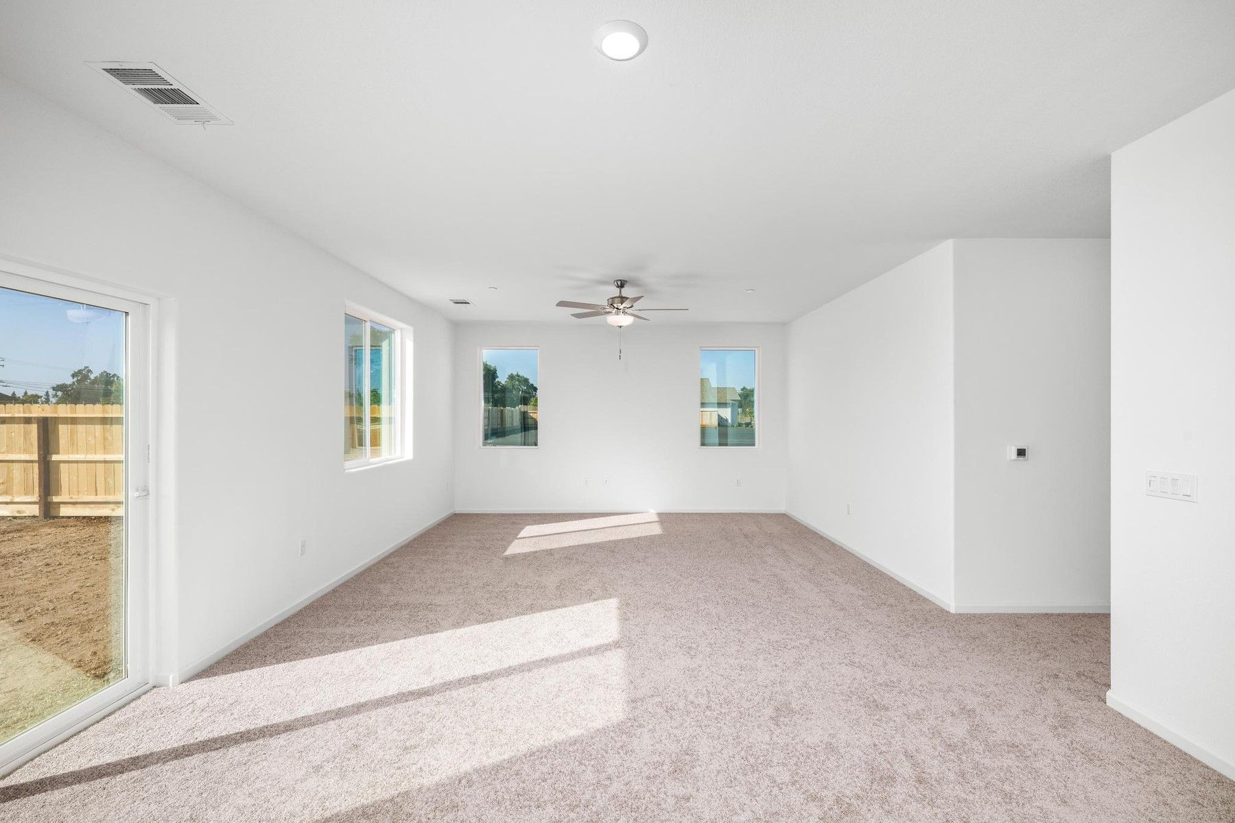The family room is spacious with a ceiling fan.