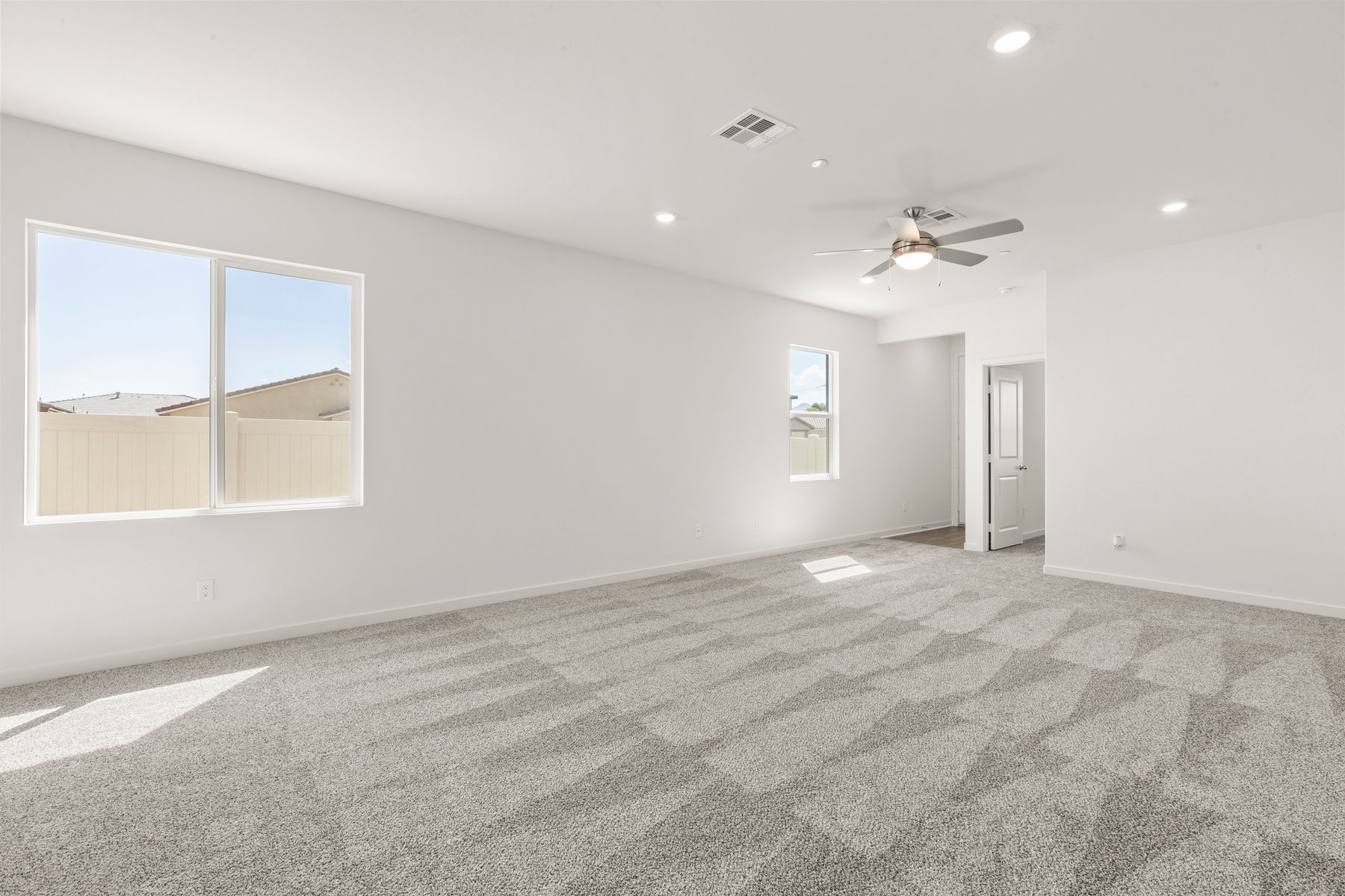 The family room is spacious with a ceiling fan.