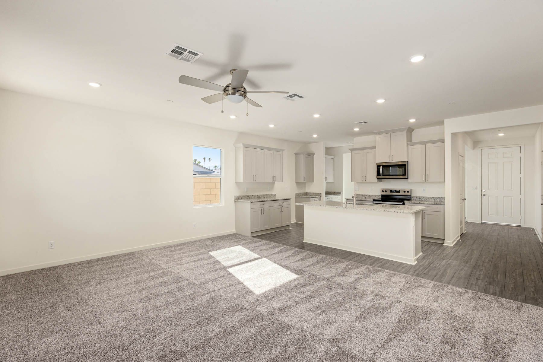 The family room is spacious with a ceiling fan.
