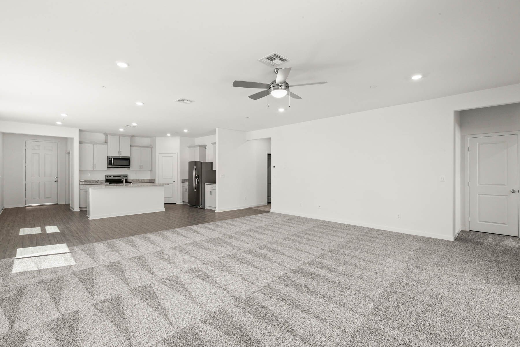 The family room is spacious with a ceiling fan.