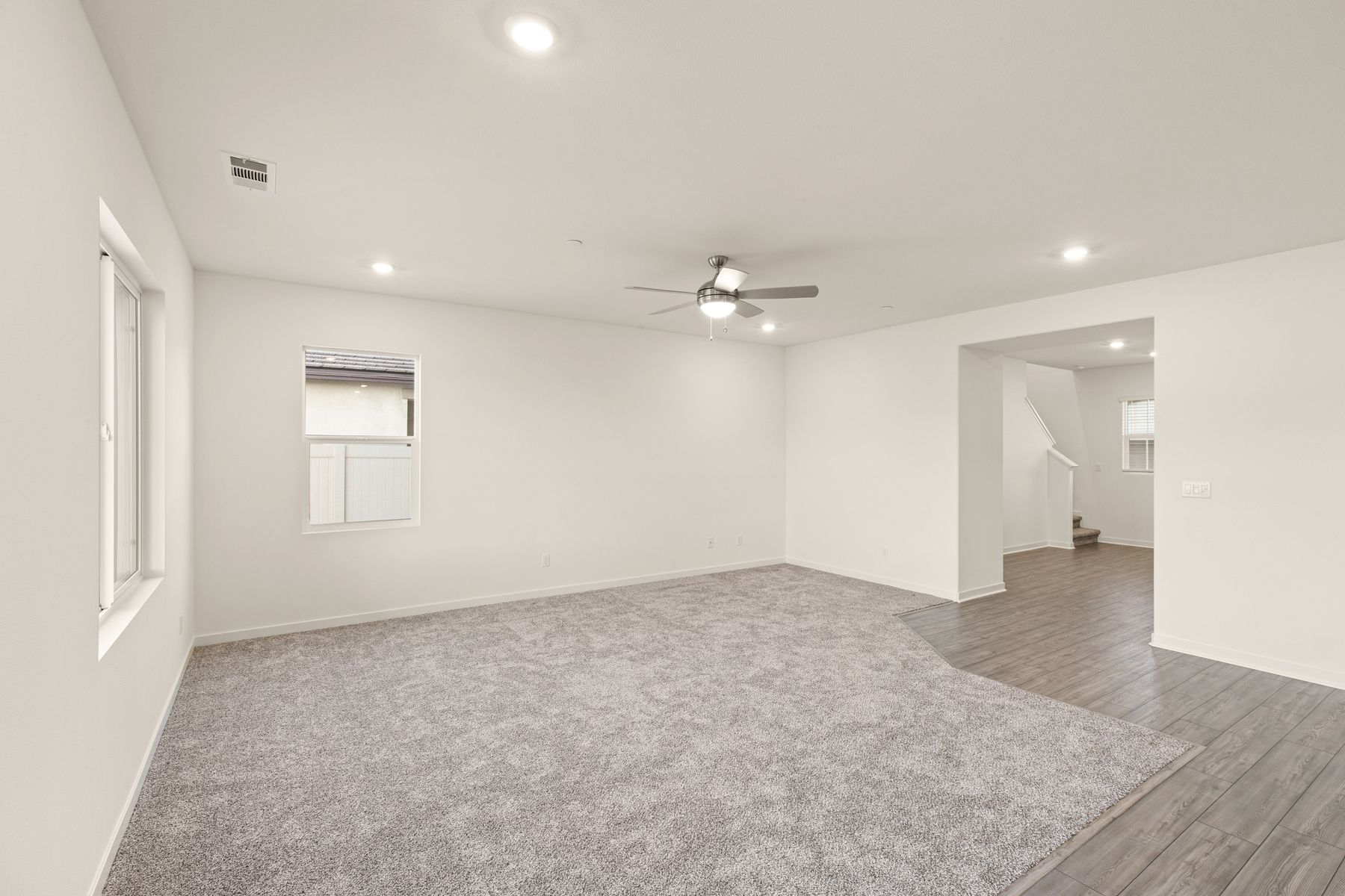 The family room is spacious with a ceiling fan.