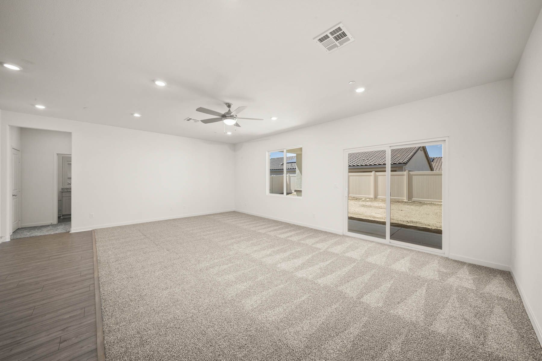 The family room is spacious with a ceiling fan.